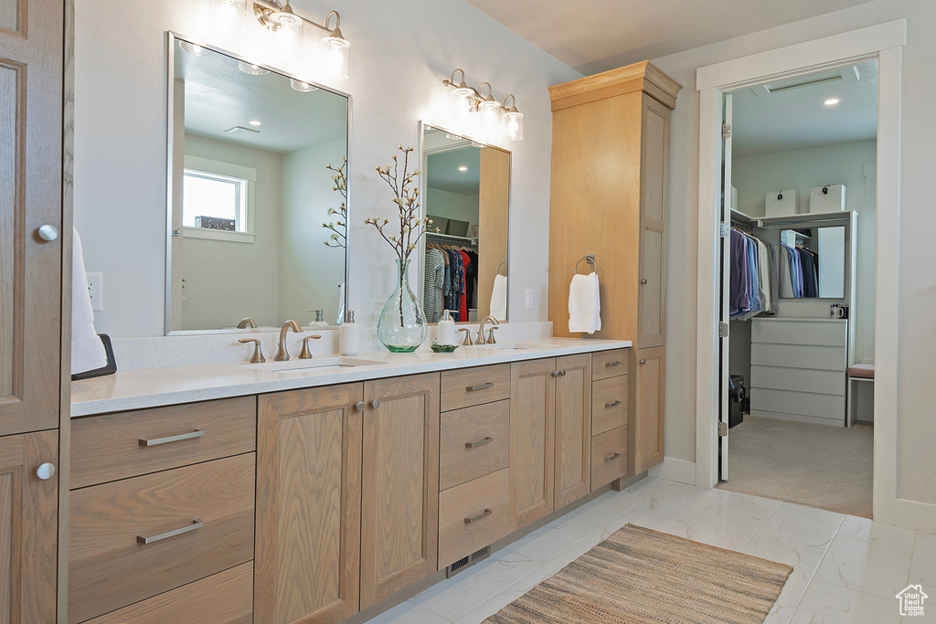 Bathroom with double vanity and tile patterned flooring