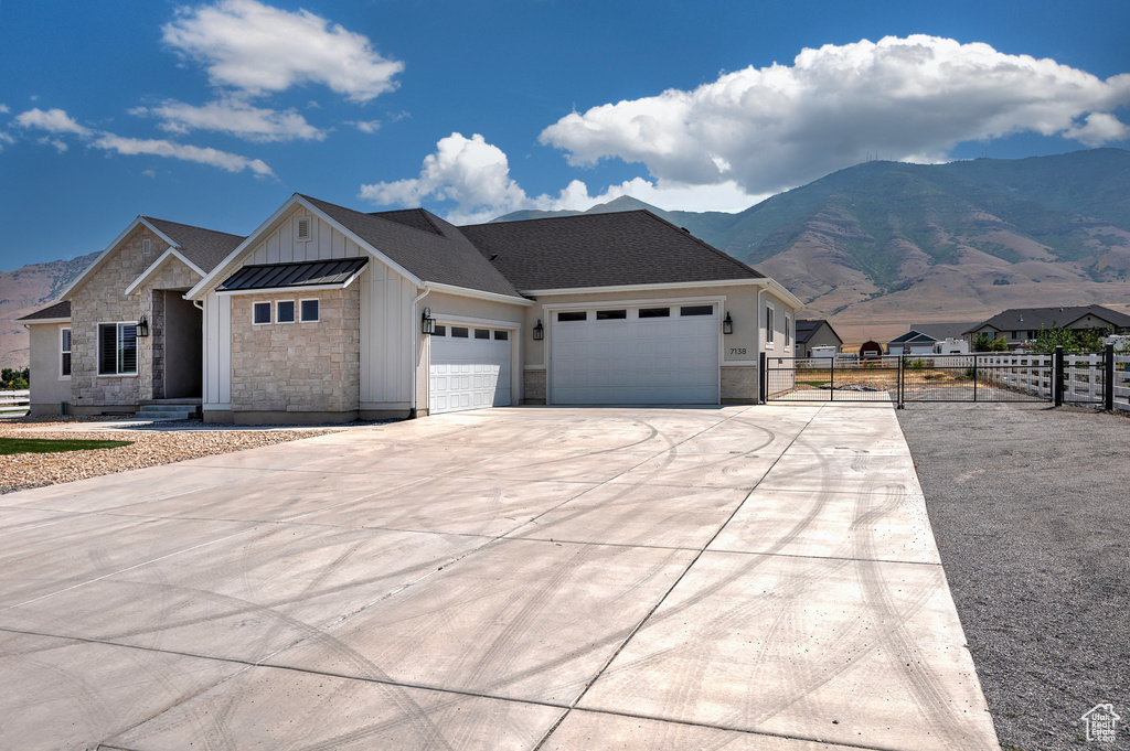 View of front of property featuring a mountain view and a garage