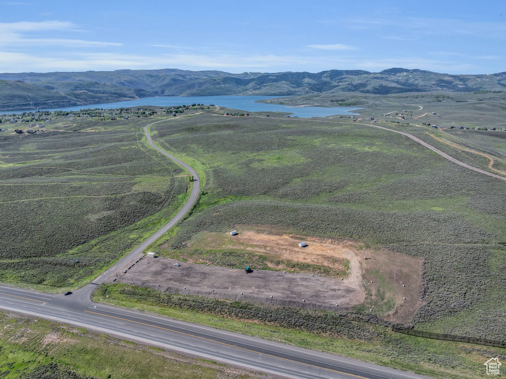 Birds eye view of property with a water and mountain view