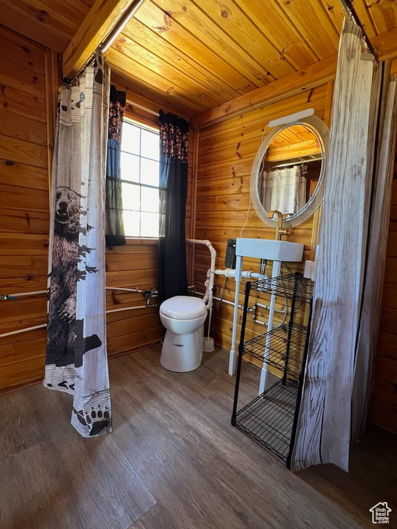 Bathroom featuring wood walls, toilet, wooden ceiling, and hardwood / wood-style flooring