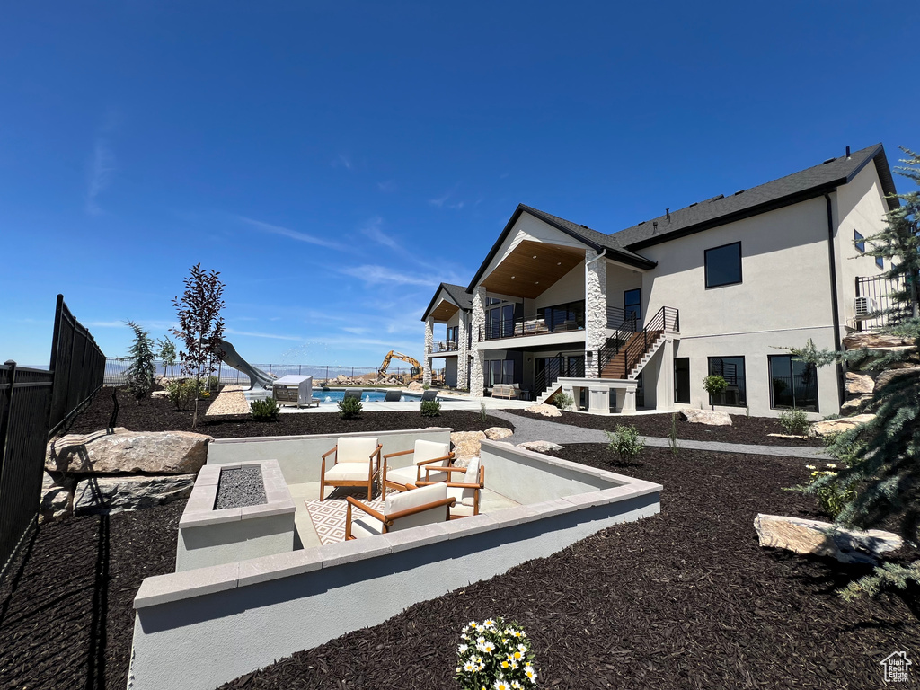 Rear view of property with a patio area, a balcony, and outdoor lounge area