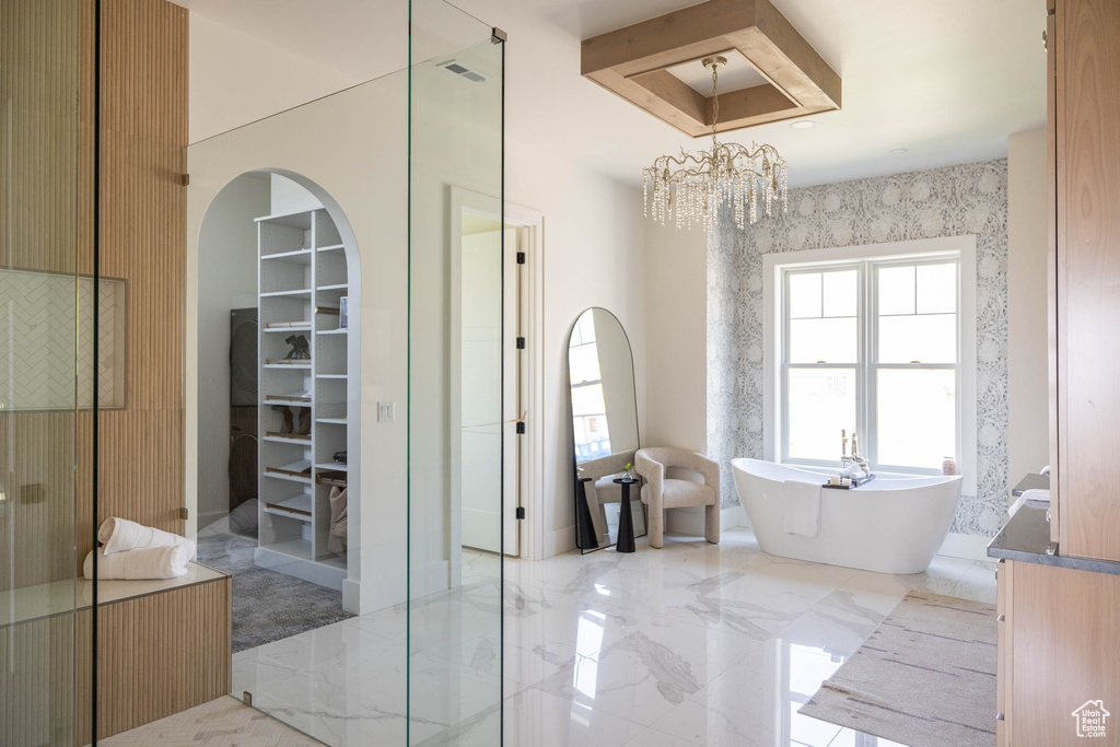 Bathroom featuring an inviting chandelier, separate shower and tub, tile patterned flooring, and plenty of natural light