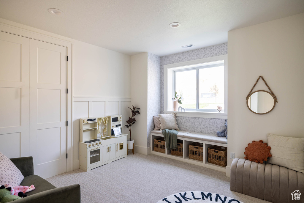 Sitting room featuring light carpet