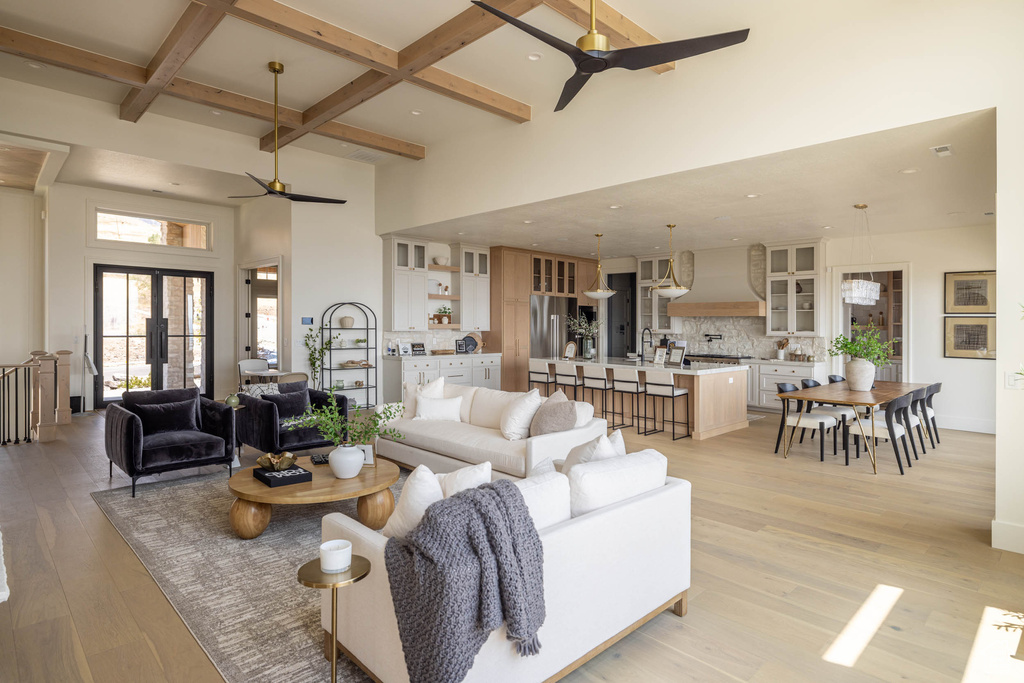 Living room with beamed ceiling, light hardwood / wood-style flooring, coffered ceiling, and ceiling fan