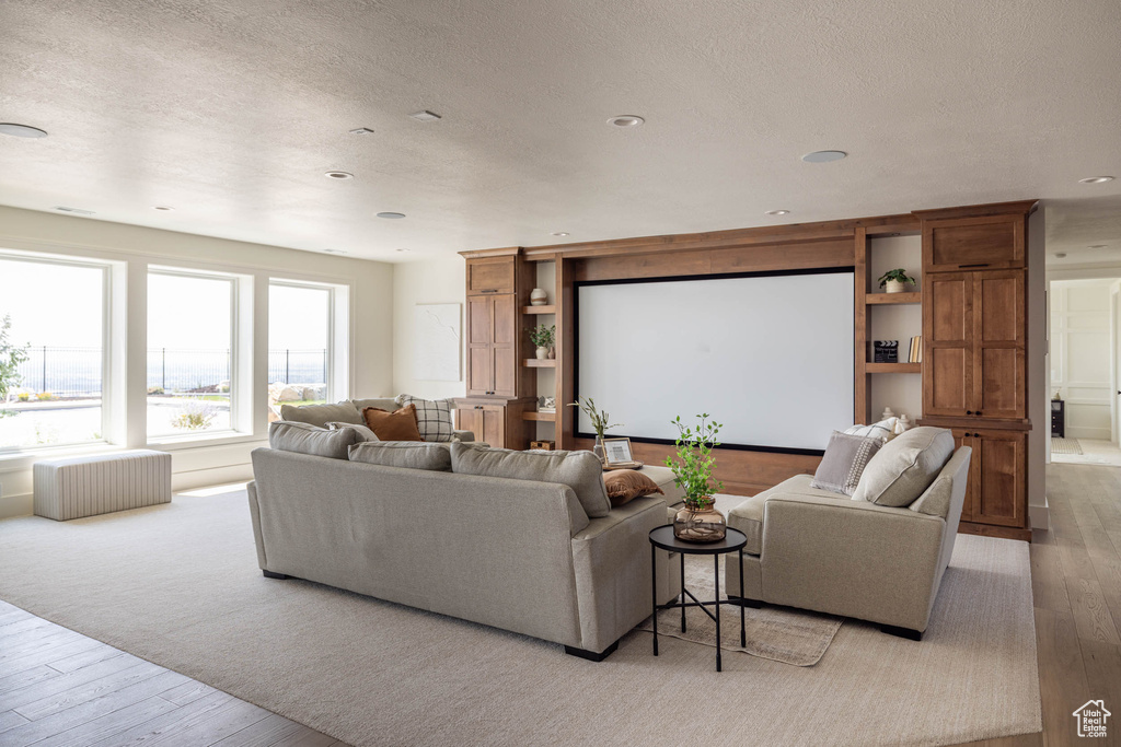 Living room featuring light wood-type flooring and a textured ceiling