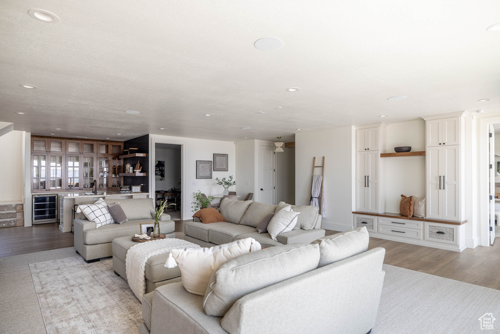 Living room featuring light hardwood / wood-style flooring and beverage cooler