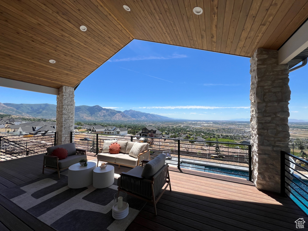 Wooden terrace with a mountain view and an outdoor hangout area