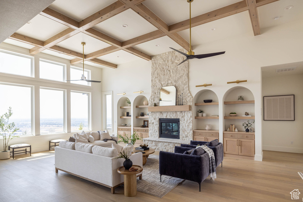 Living room with light hardwood / wood-style flooring, a fireplace, and ceiling fan