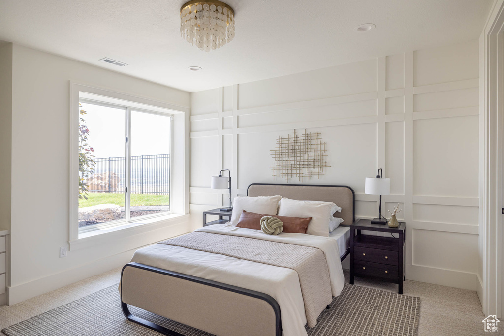 Bedroom featuring light carpet