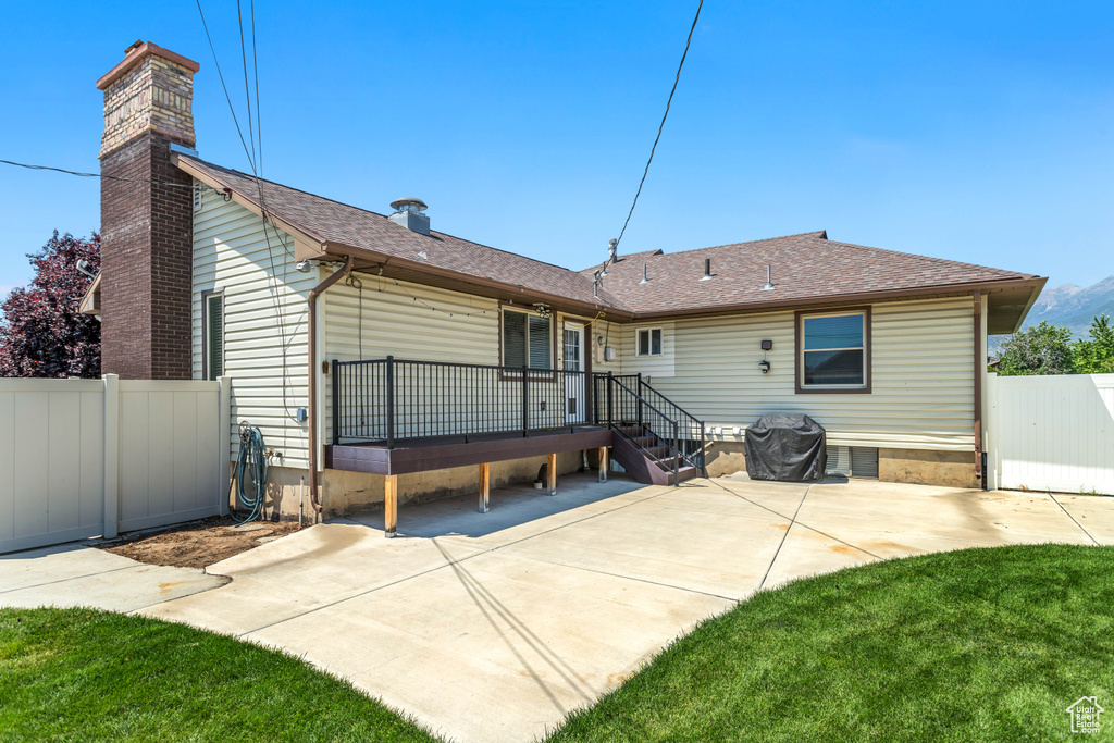 Rear view of property with a patio area and a yard