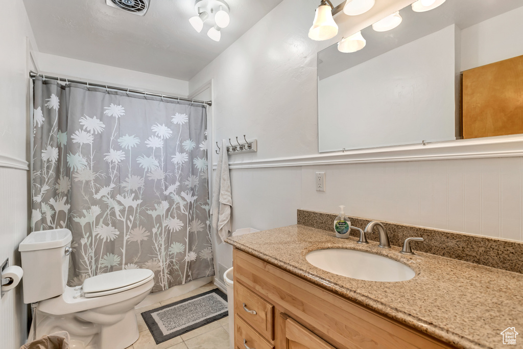 Bathroom with tile patterned floors, vanity, and toilet