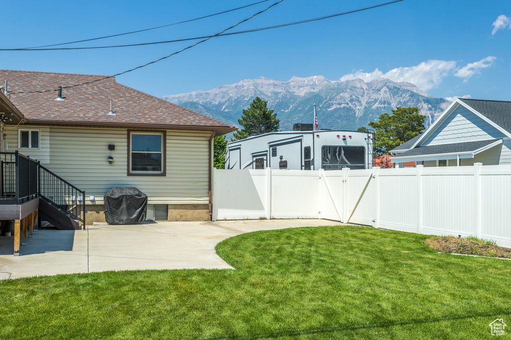 View of yard featuring a mountain view and a patio area