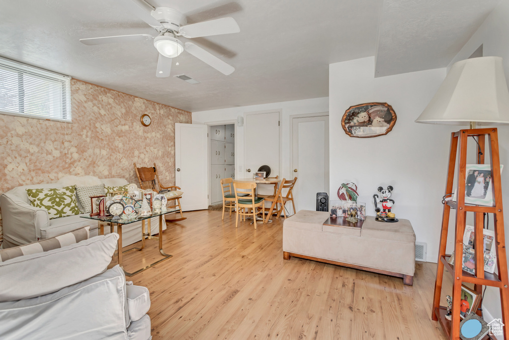 Living room featuring light wood-type flooring and ceiling fan