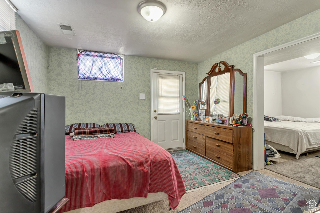 Bedroom featuring a textured ceiling and carpet flooring