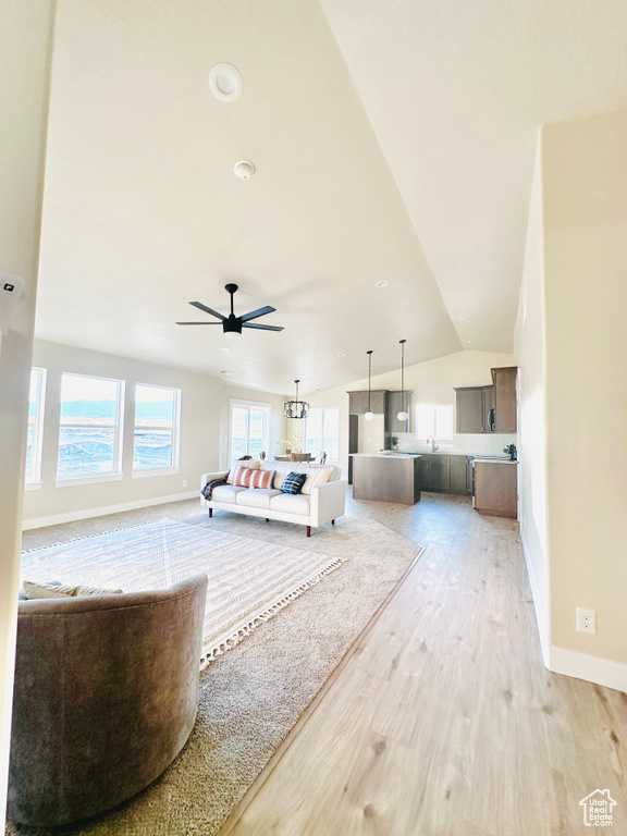 Unfurnished bedroom with lofted ceiling and light wood-type flooring