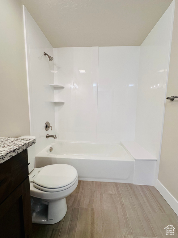 Full bathroom featuring vanity, toilet, shower / bathing tub combination, and hardwood / wood-style floors