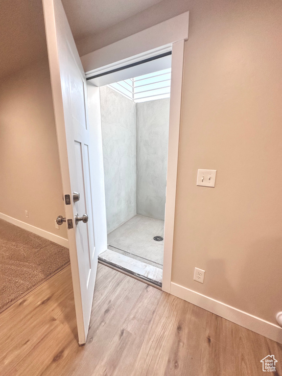 Bathroom featuring hardwood / wood-style flooring and a shower