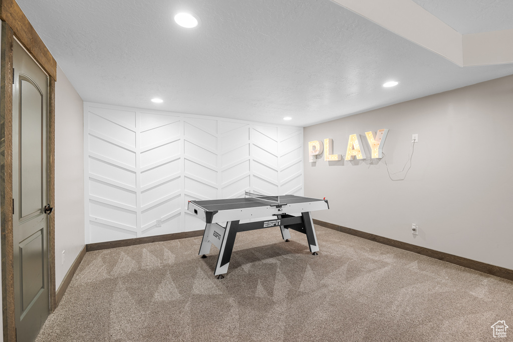 Carpeted office featuring a textured ceiling