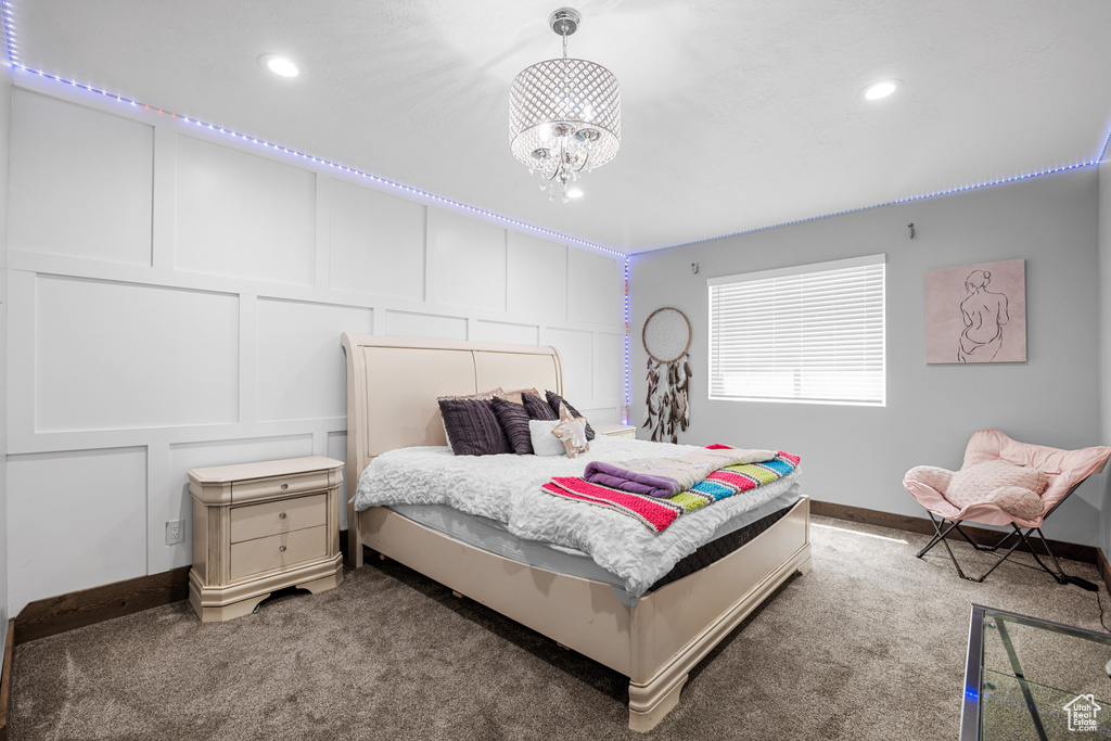 Bedroom with carpet floors and an inviting chandelier