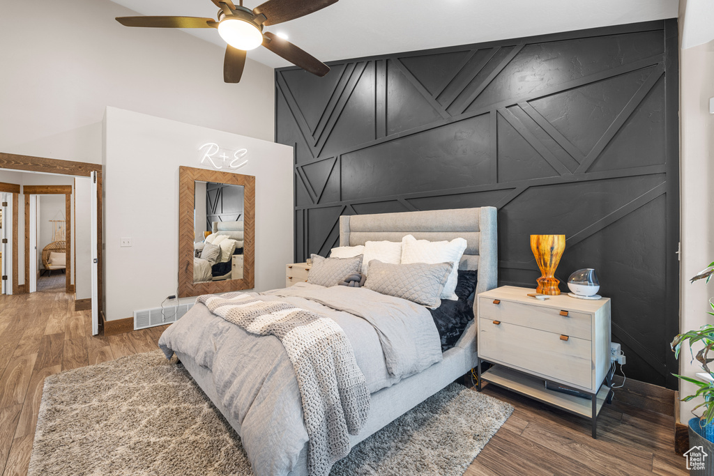 Bedroom with ceiling fan and dark hardwood / wood-style floors