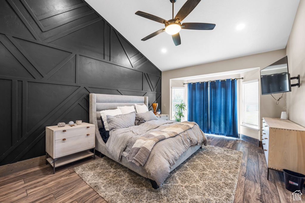 Bedroom featuring ceiling fan, dark hardwood / wood-style flooring, and lofted ceiling