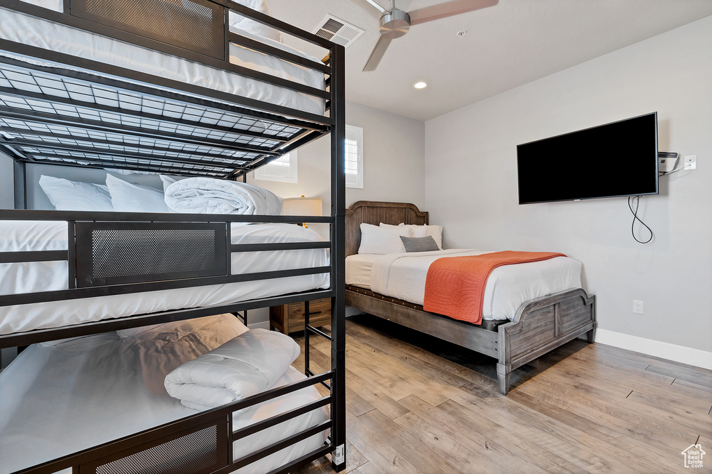 Bedroom with ceiling fan and wood-type flooring