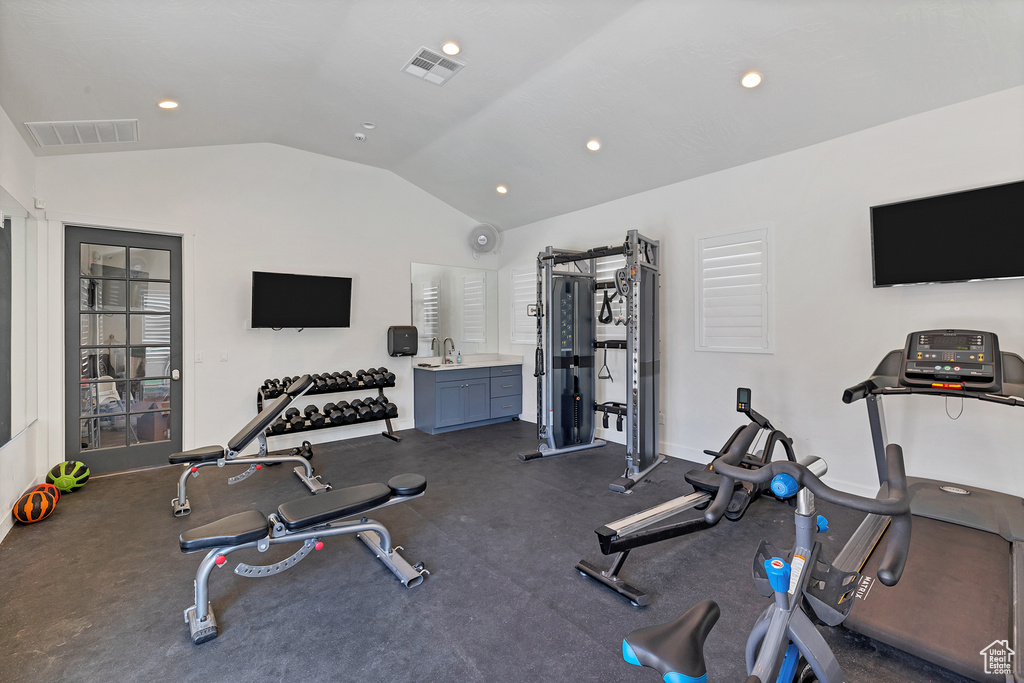 Workout area with sink and lofted ceiling