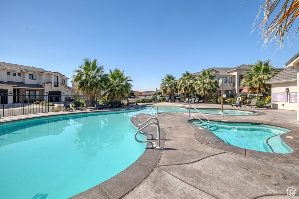 View of swimming pool with a patio area and a community hot tub