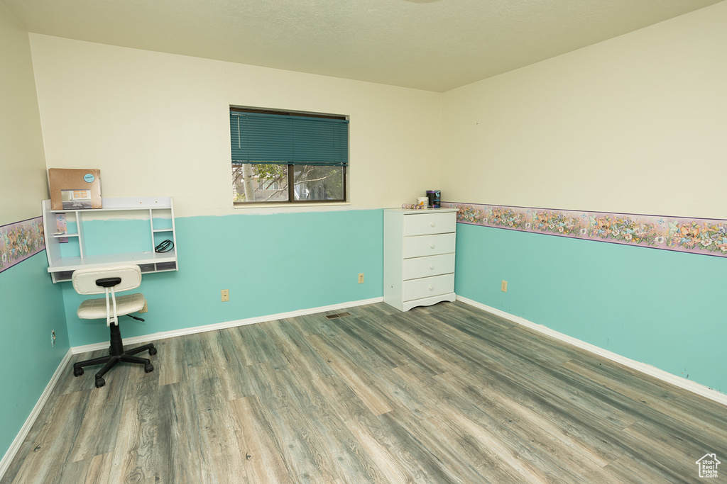 Unfurnished office featuring hardwood / wood-style floors