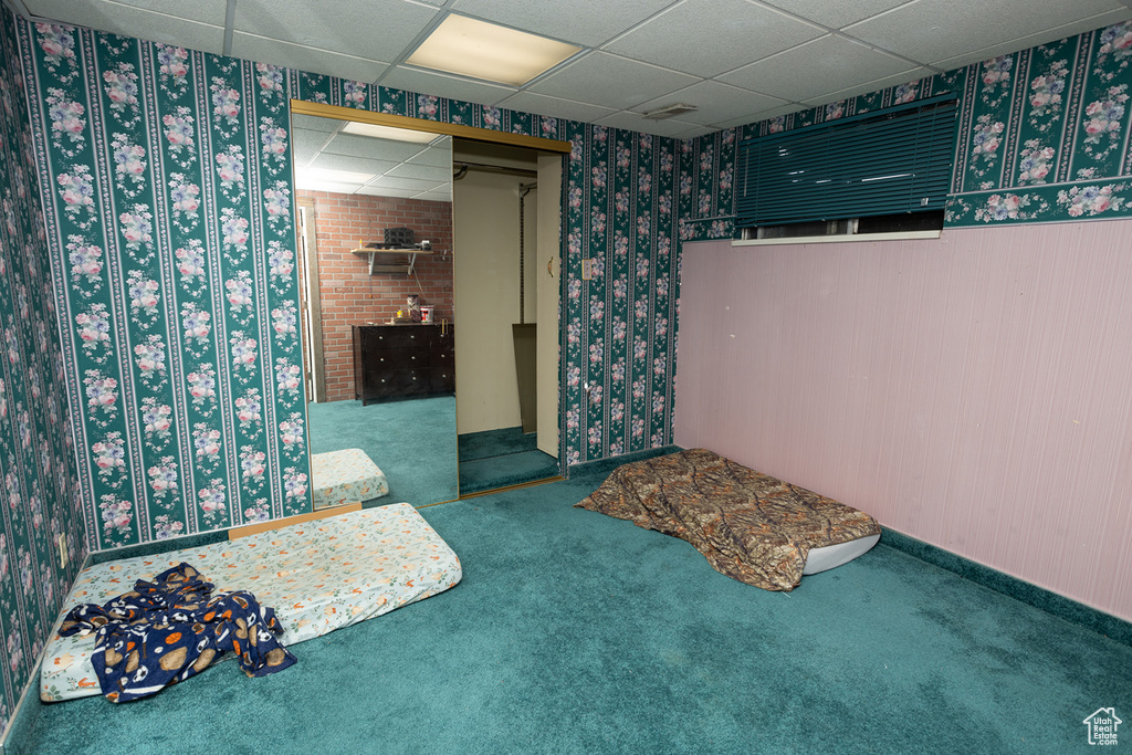 Carpeted bedroom with a drop ceiling