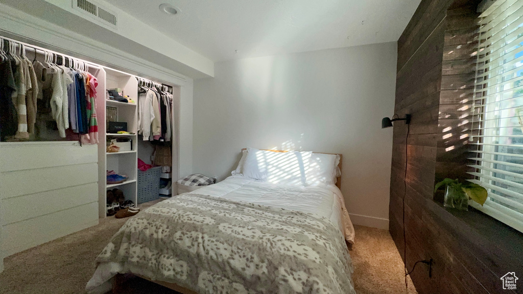 Carpeted bedroom with a closet