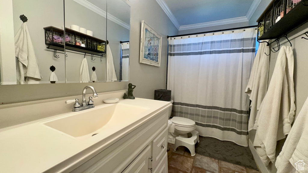 Bathroom with vanity, crown molding, toilet, and tile patterned floors