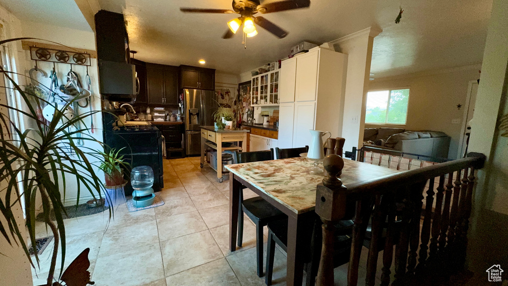 Dining room with light tile patterned floors and ceiling fan