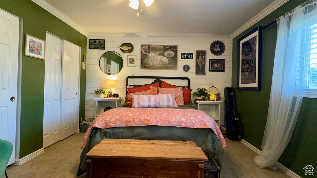 Carpeted bedroom with ceiling fan and ornamental molding