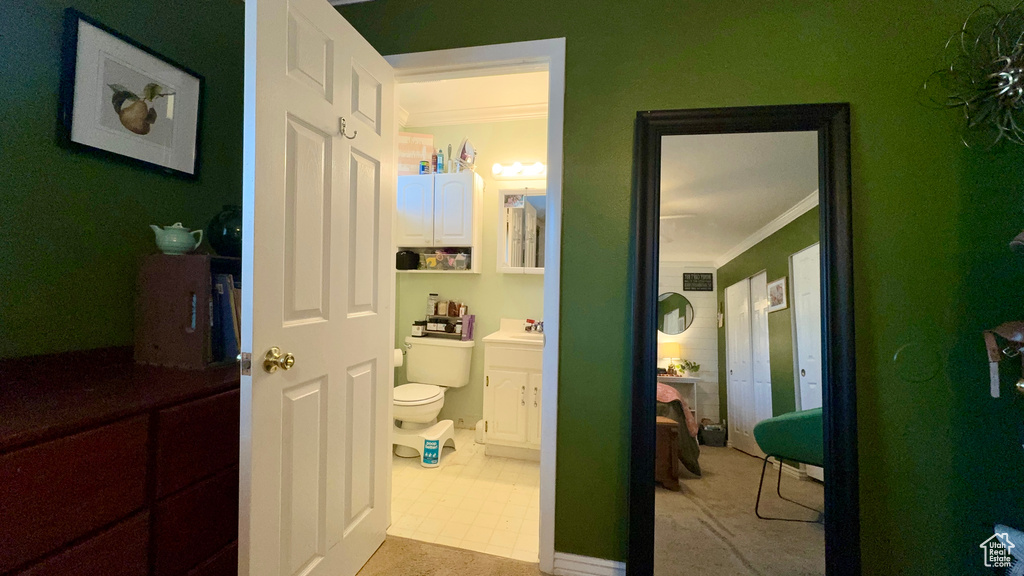 Interior space featuring ornamental molding, sink, and tile patterned floors