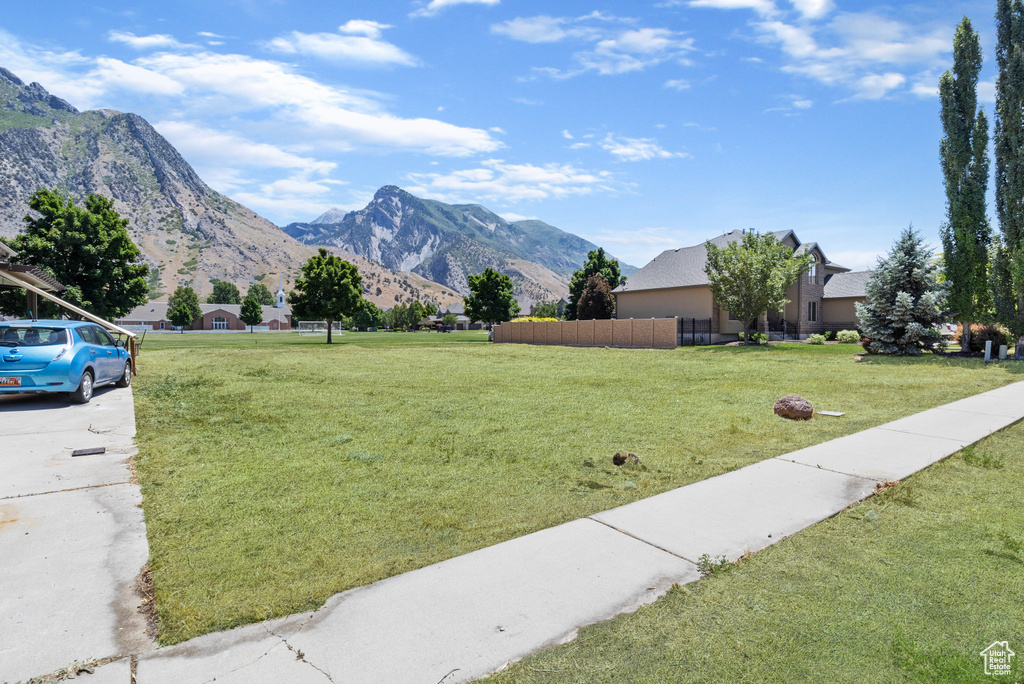 View of front facade featuring a front lawn and a mountain view