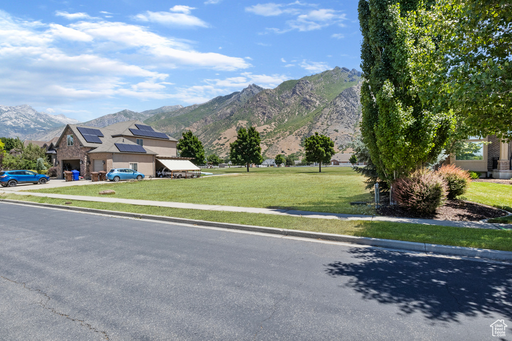 View of front facade featuring a mountain view and a front yard