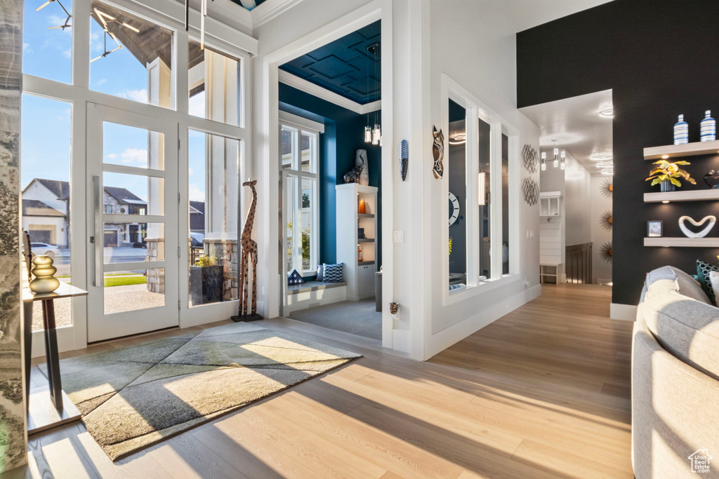 Interior space with crown molding and hardwood / wood-style floors