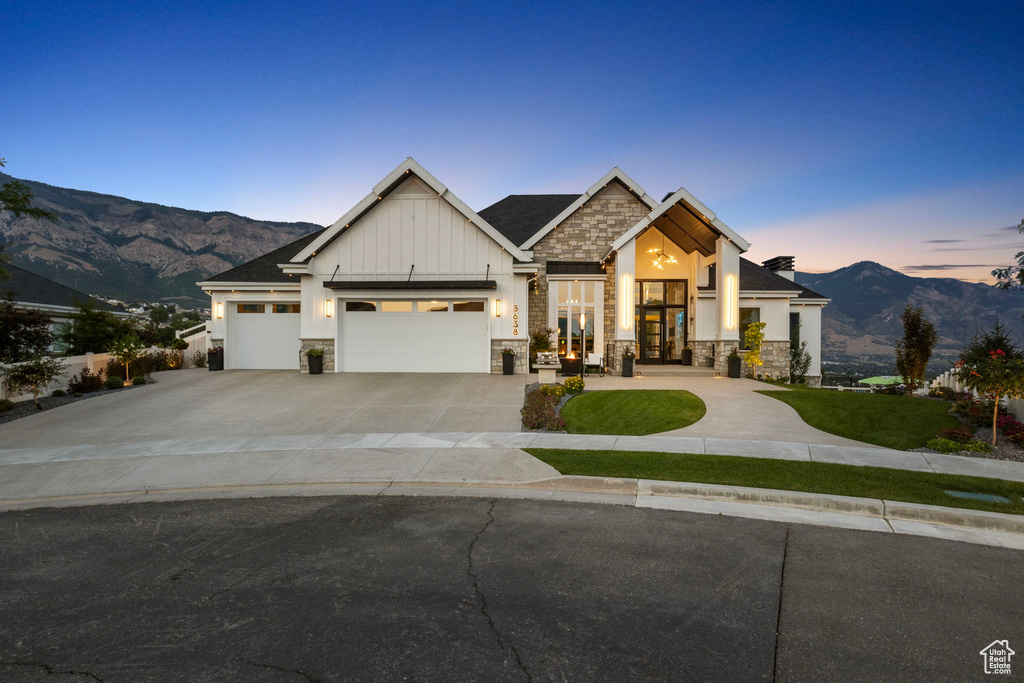 Craftsman-style house with a garage and a mountain view