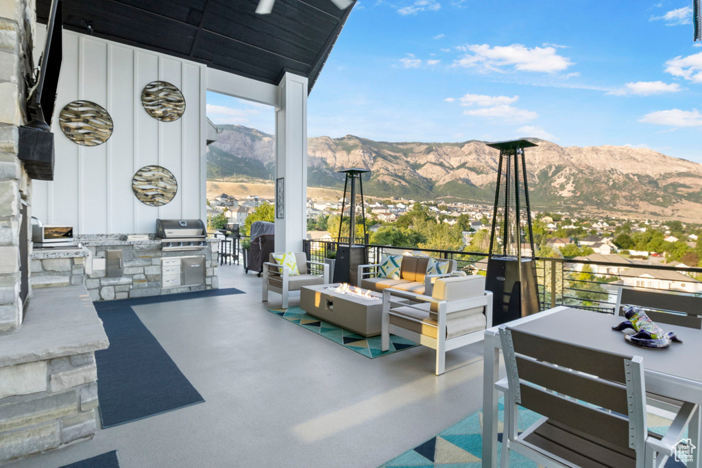 View of patio / terrace with a mountain view, an outdoor kitchen, outdoor lounge area, and grilling area