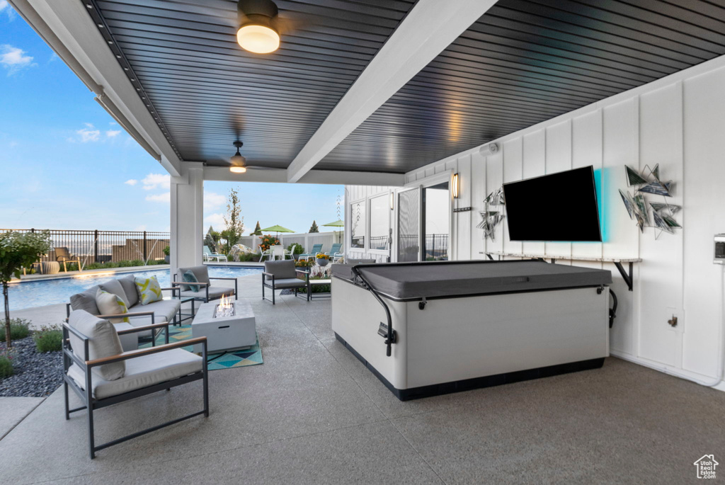 View of patio with an outdoor living space and a fenced in pool