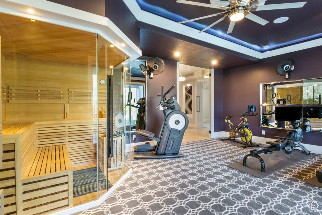 Exercise room featuring ceiling fan and light tile patterned floors