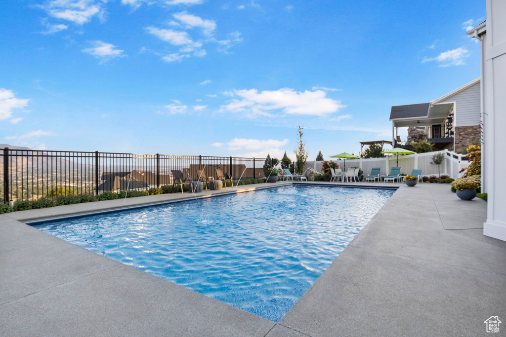 View of swimming pool featuring a patio