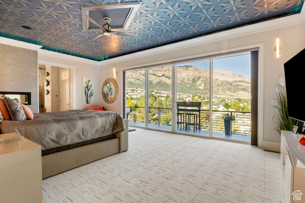 Bedroom featuring access to outside, carpet floors, and ornamental molding