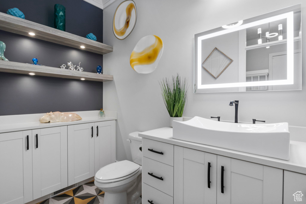 Bathroom with vanity, tile patterned flooring, and toilet