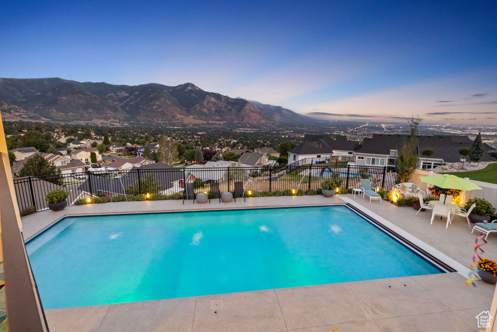 View of swimming pool featuring a patio area and a mountain view