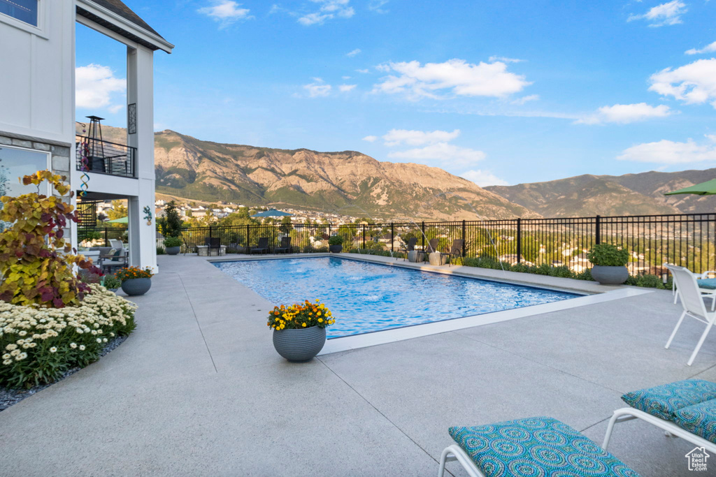 View of pool featuring a mountain view and a patio