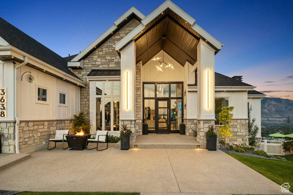 Exterior entry at dusk with central air condition unit