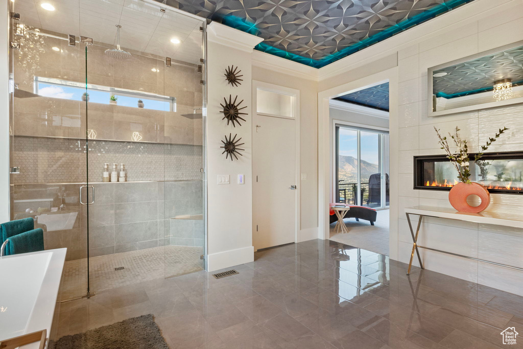 Bathroom featuring a mountain view, shower with separate bathtub, tile patterned floors, and a multi sided fireplace