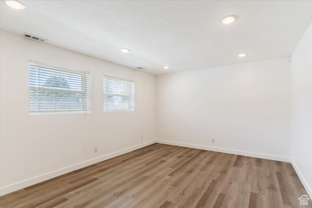 Unfurnished room with light hardwood / wood-style flooring